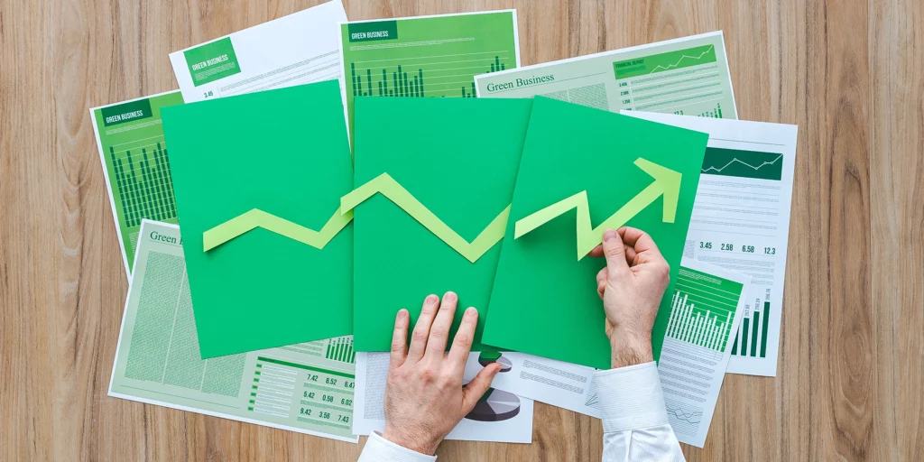 A person lies a growing graph out of paper