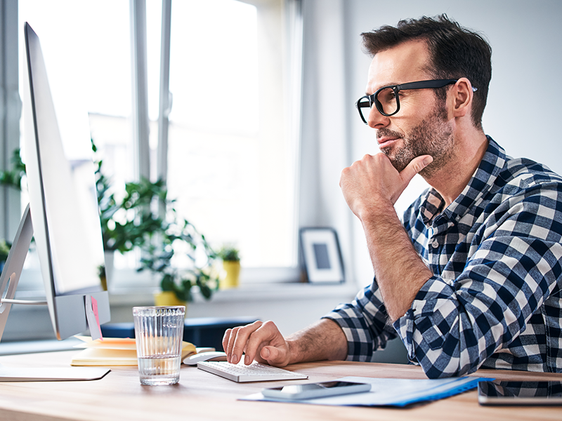 An office worker watches a training session attentively.